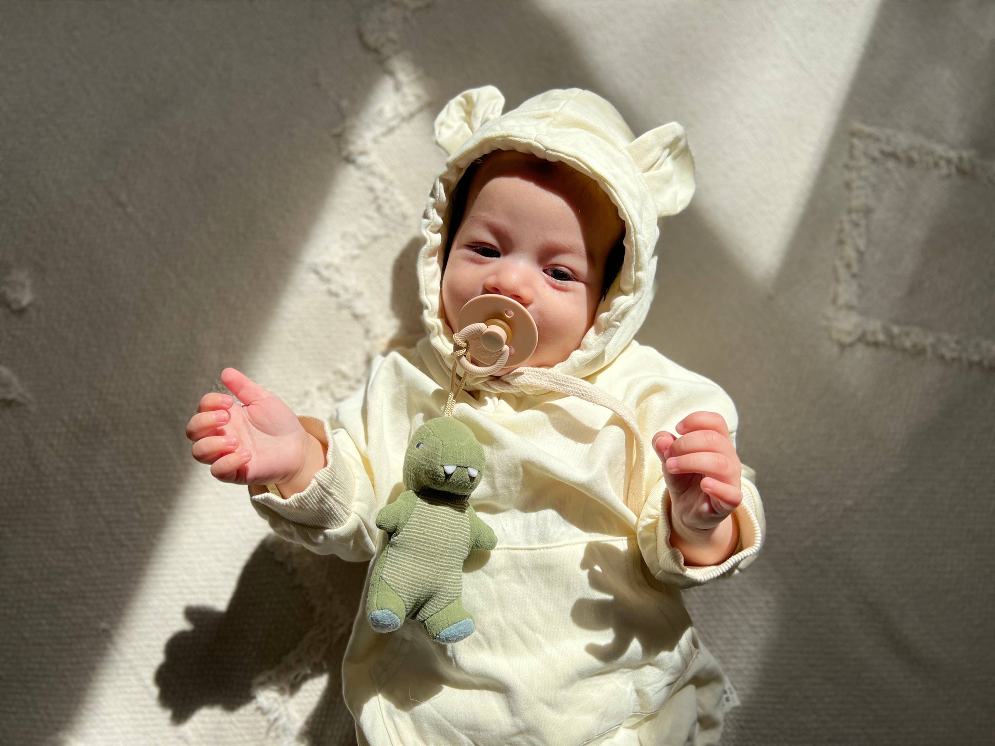 Itzy Bitzy natural rubber pacifier and stuffed dinosaur